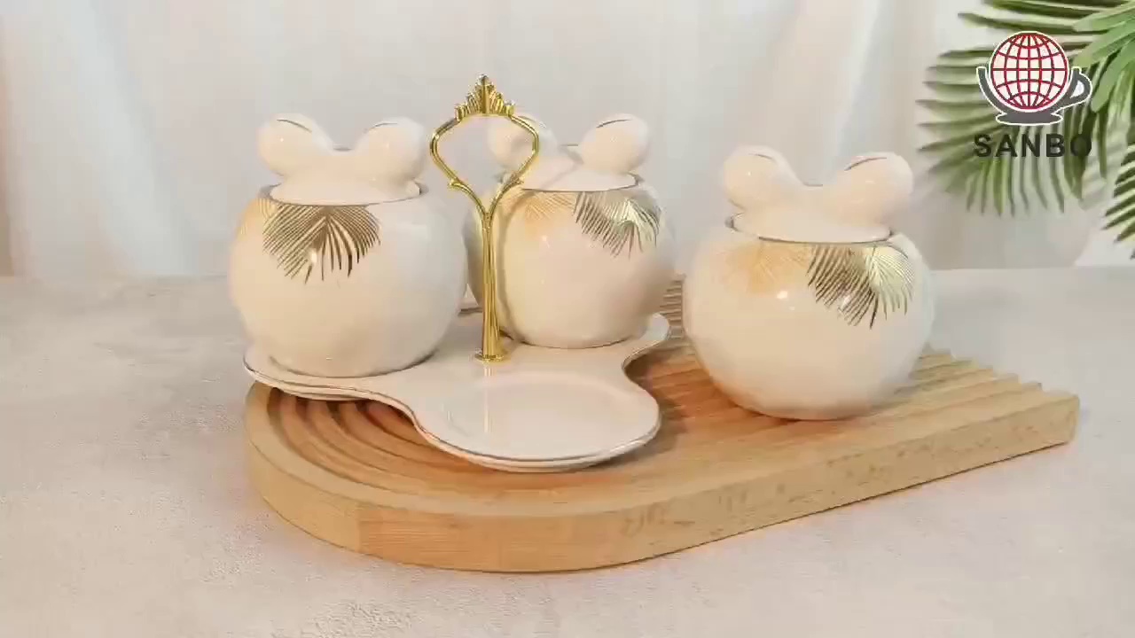 kitchen storage jars; white and gold canisters; white ceramic canisters